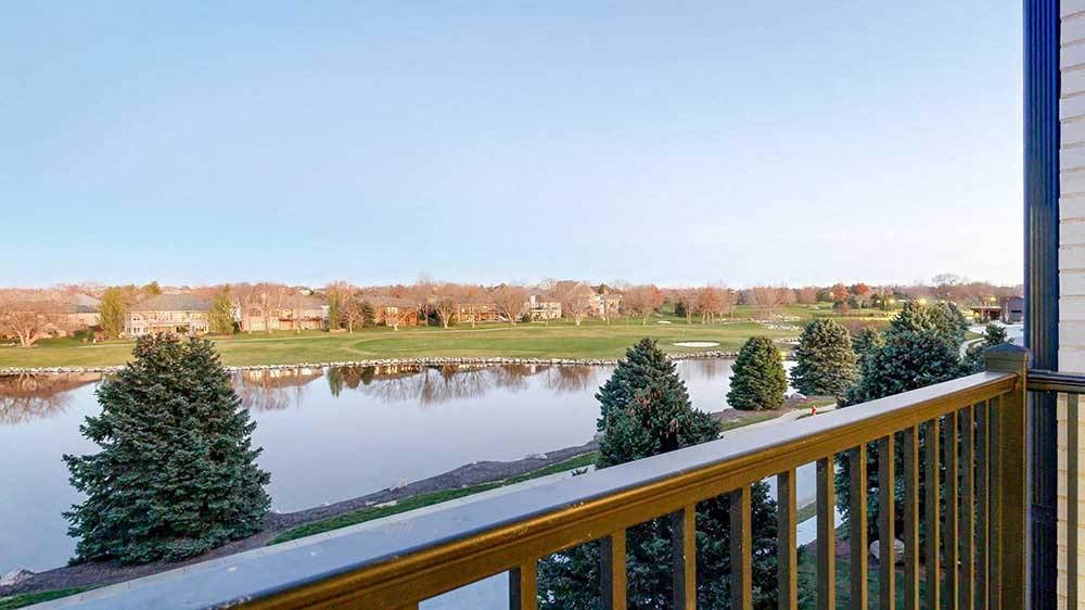 a view from a balcony overlooking a pond and the Wilderness Ridge Golf Course