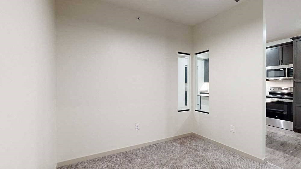 a sleeping area with a privacy wall with a small window