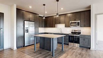 a modern kitchen with dark wood cabinets and stainless steel appliances