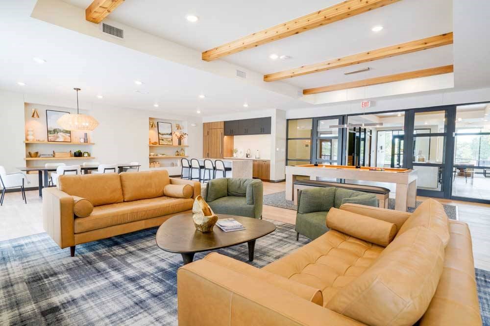 A clubroom with a TV lounge and conversational seating.