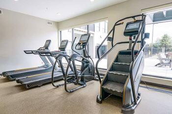 a 24-hour fitness center with treadmills, ellipticals, and a Stairmaster