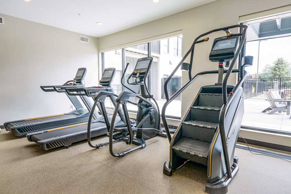 a 24-hour fitness center with treadmills, ellipticals, and a Stairmaster