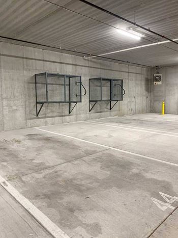 an underground climate-controlled parking garage with wall-mounted storage