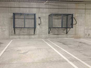 an underground climate-controlled parking garage with wall-mounted storage