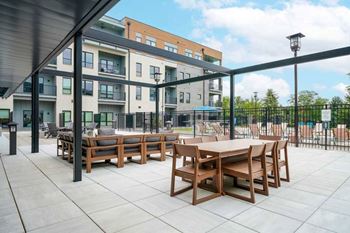 A courtyard patio space with lounge seating and an outdoor dining setup.