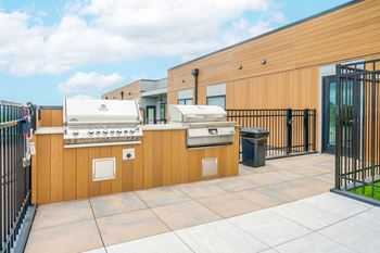 a rooftop patio with stainless steel grilling stations