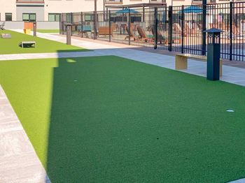 a turf green space with an area designated for bocce ball