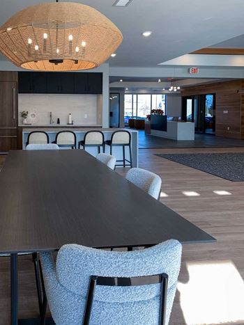 a large dining table in the community clubroom for residents to use