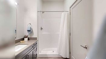 a bathroom with a large mirror, vanity, and modern lighting