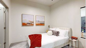 a studio bedroom setup with contemporary decor and artwork