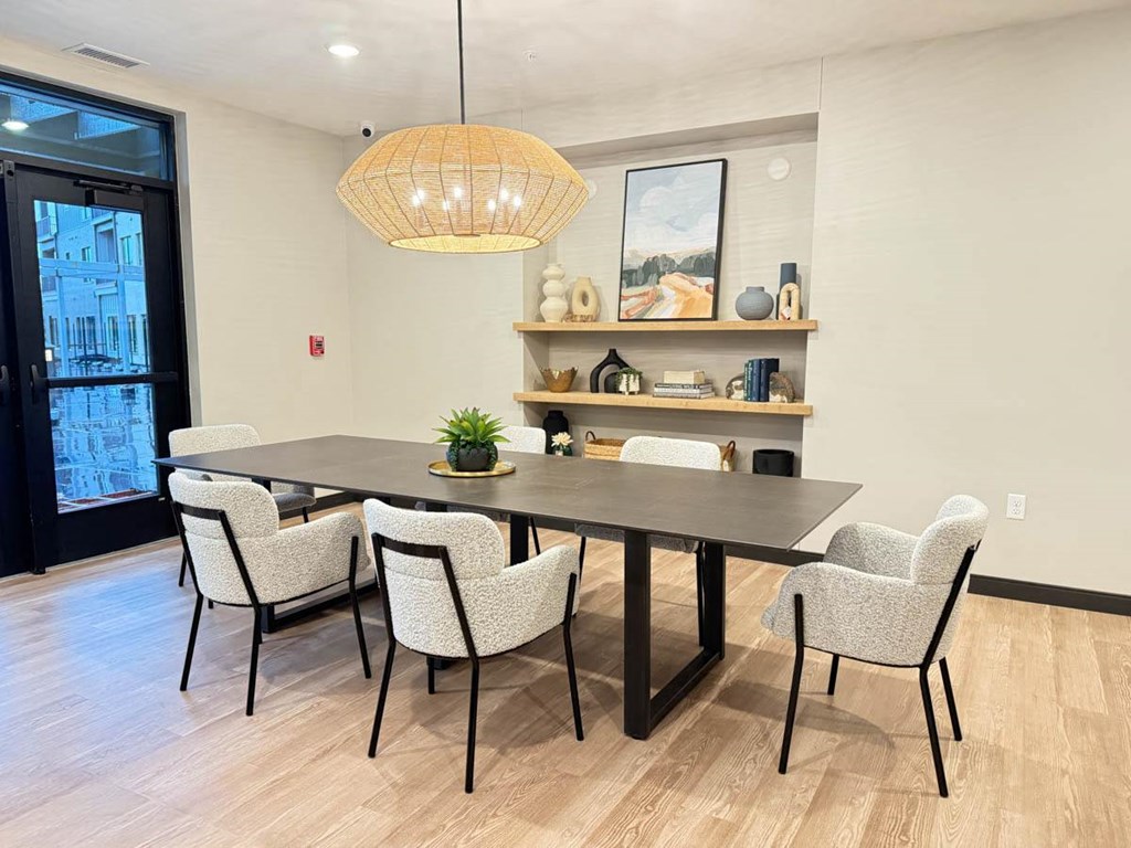 Clubroom dining space a dining space with a table and chairs and inset shelves with decor along back wall