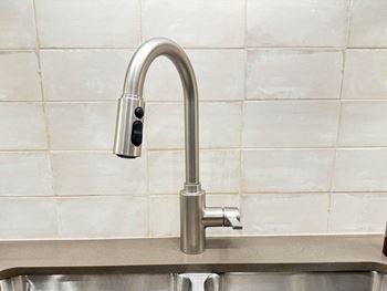 a close up of a faucet in a kitchen sink