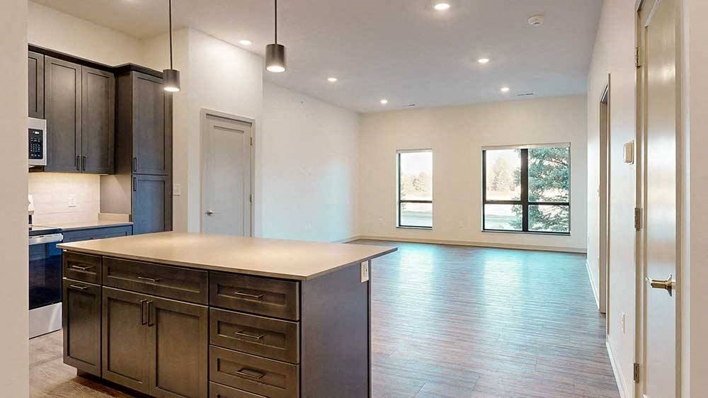 a view of a spacious living room from a kitchen island countertop