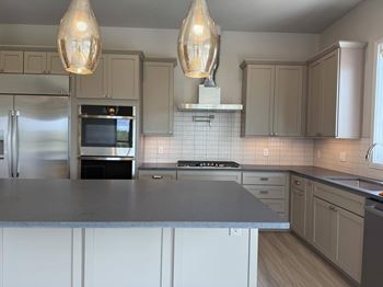 A kitchen with a stove top oven and a microwave.