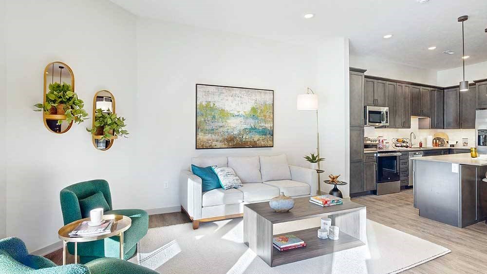 a furnished living room with midcentury modern furniture and plenty of natural light