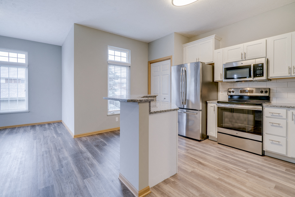 Kitchen with stainless steel appliances and island at Cascade Pines duplex and townhomes