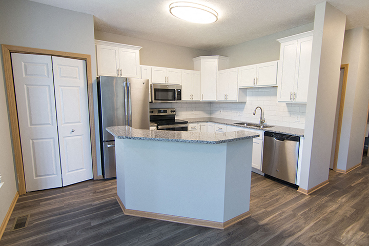 Beautifully renovated kitchen with subway tile and hardwood-like flooring at Cascade Pines Town-homes Lincoln Nebraska