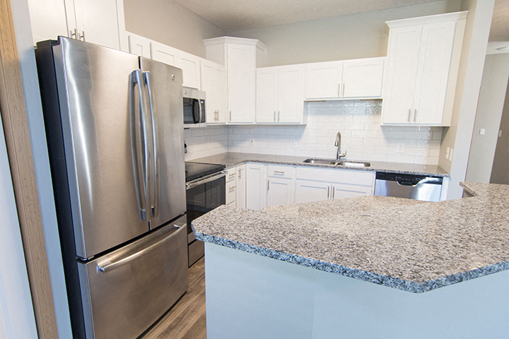 Stainless-steel appliances and hardwood-like flooring at Cascade Pines Town-homes Lincoln Nebraska