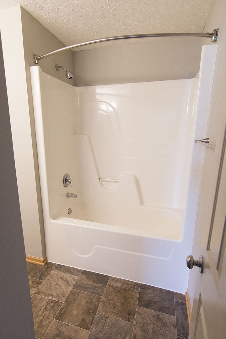 Shower and bathtub with curved curtain bar at Cascade Pines Town-homes Lincoln Nebraska