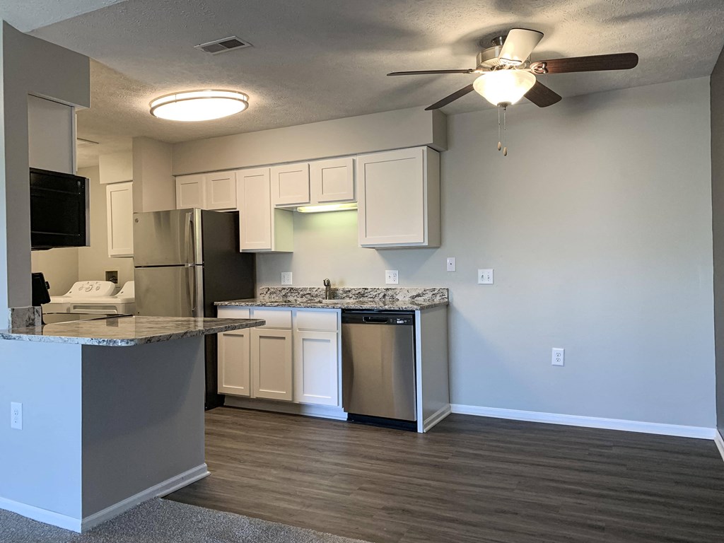 Renovated kitchen with white cabinets and stainless steel appliances at Eagle Run Apartments in Omaha Nebraska