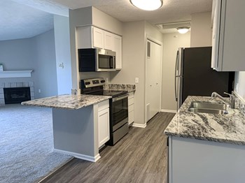Renovated kitchen with white cabinets and stainless steel appliances at Eagle Run Apartments in Omaha Nebraska - Photo Gallery 5