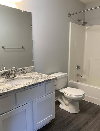 Bathroom with white vanity for storage and large mirror with great lighting at Eagle Run Apartments in Omaha Nebraska - Photo Gallery