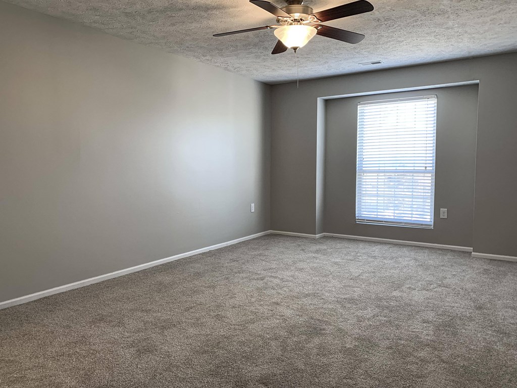 Carpeted bedroom with walk in closet at Eagle Run Apartments in Omaha Nebraska