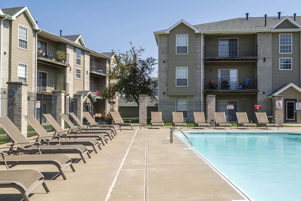 Outdoor swimming pool with lounge chairs at Eagle Run Apartments in northwest Omaha 68164