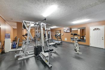 Fitness center with weightlifting machines and cardio equipment at Eagle Run Apartments in northwest Omaha 68164