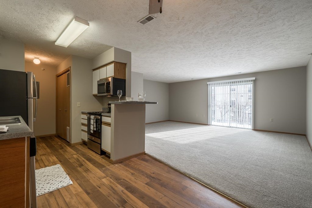 A kitchen area with a refrigerator, microwave, and stove