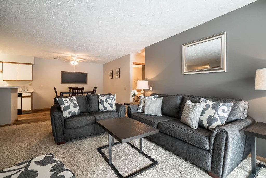 A living room with grey couches and a coffee table.