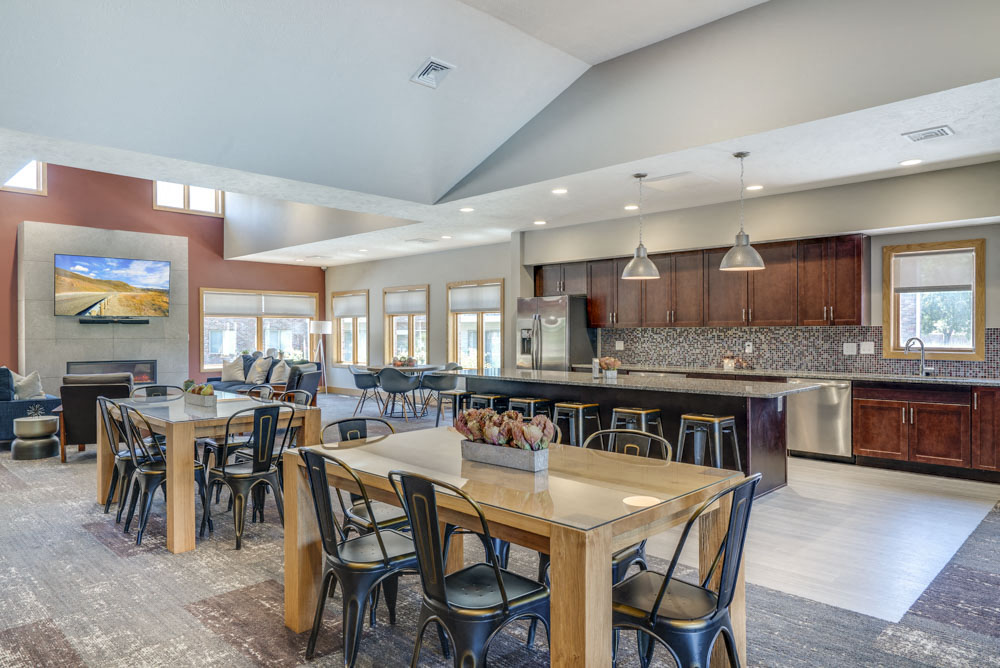 Clubhouse with seating and kitchen for resident's use at Fountain Glen Apartments