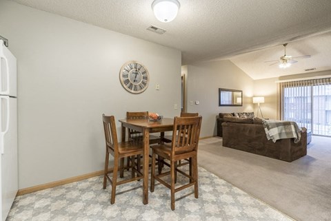 a dining room table and a living room with a couch