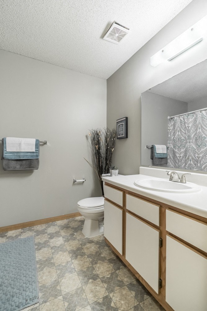 Traditional style bathroom with white cabinets with wooden trim