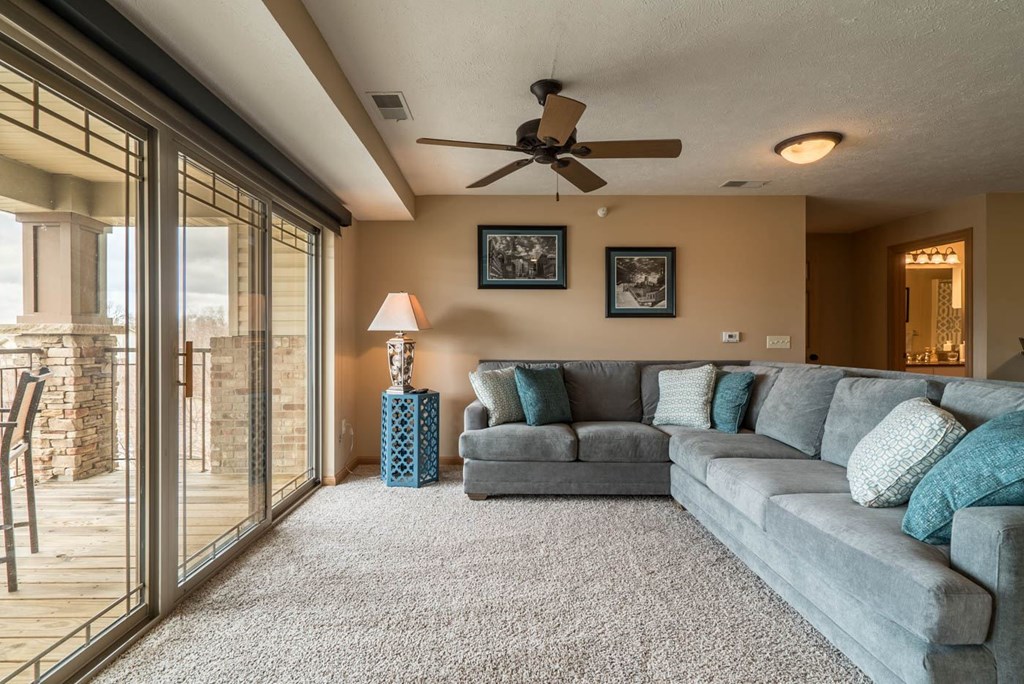 a living room with a couch and a ceiling fan