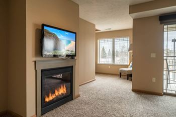 a living room with a fireplace and a tv