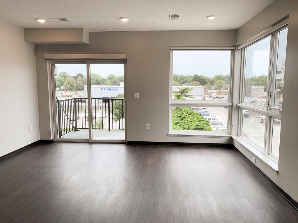 Living room view through corner floor to ceiling windows and sliding door that look out onto north Lincoln, Nebraska