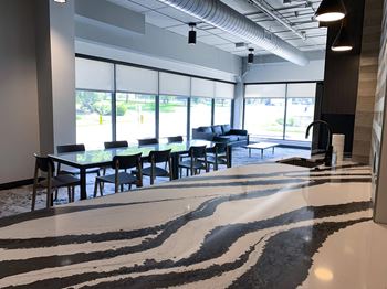 community room with lounge seating and kitchen at Haven at Uptown in Lincoln, NE
