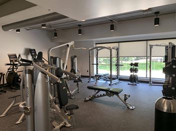 Fitness center with strength training and cardio equipment at Haven at Uptown