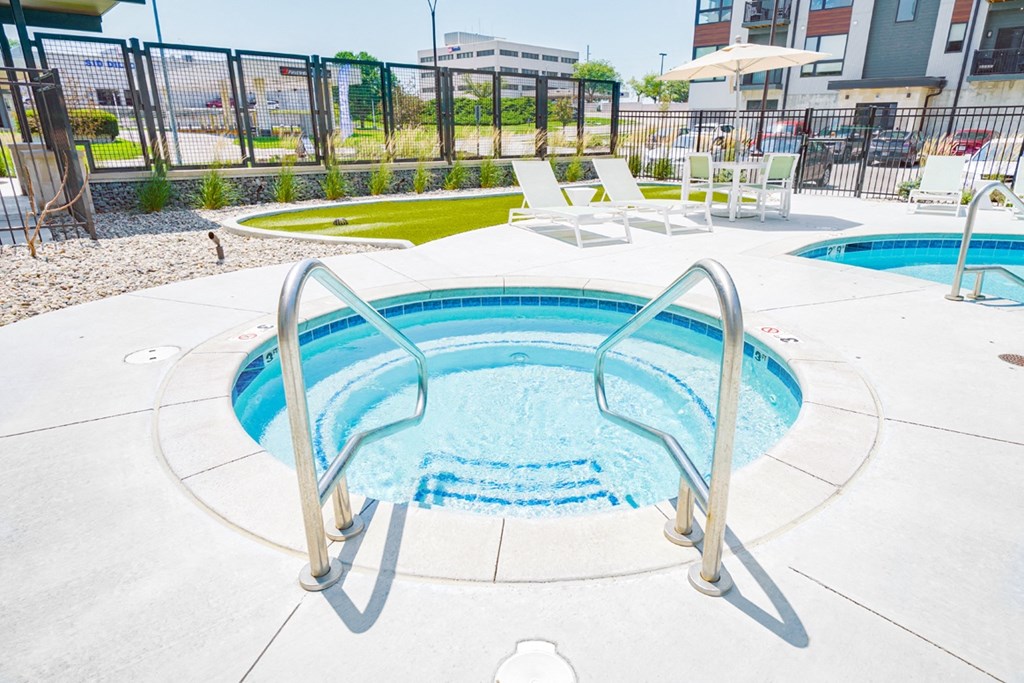 a relaxing in-ground hot tub at the Haven at Uptown apartments