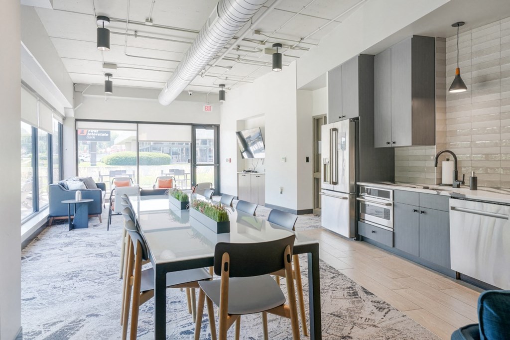 community room with lounge seating and kitchen at Haven at Uptown in Lincoln, NE