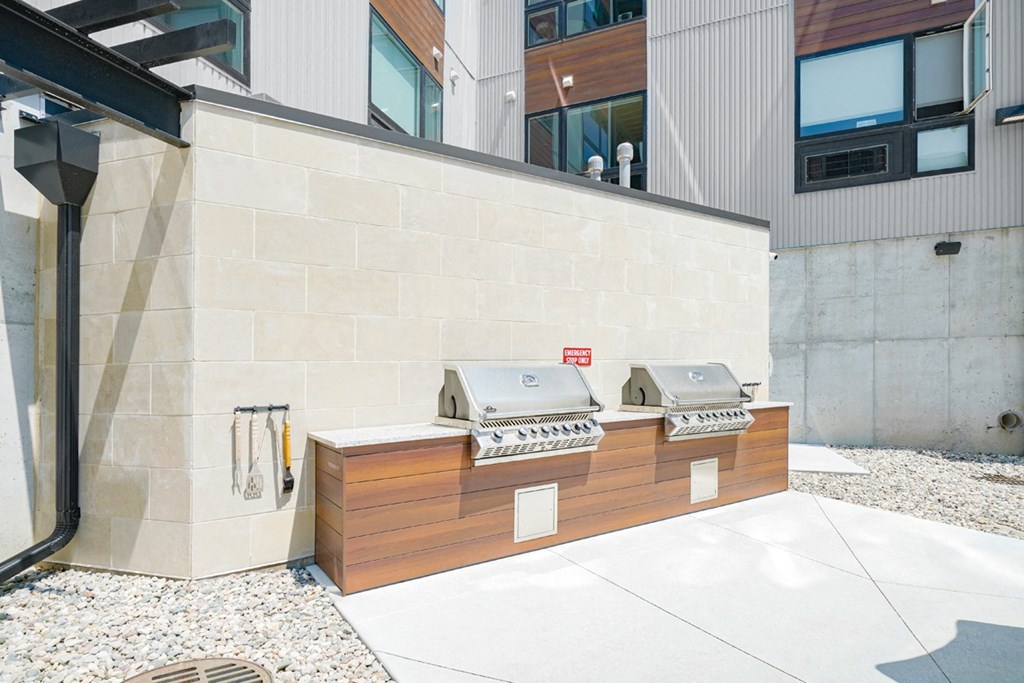 two poolside grills outside of Haven at Uptown apartments