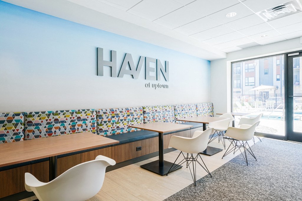 a dining room with tables and chairs and a hansen logo