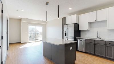 Open concept kitchen and living space in the Bliss floor plan at Haven at Uptown in Lincoln, NE