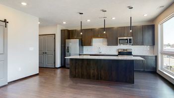 Spacious living-dining space connected to the kitchen in this open concept Melody floor plan at Haven at Uptown in Lincoln, NE