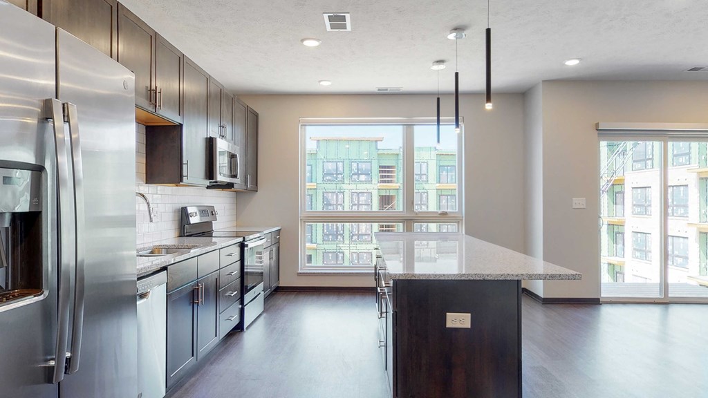 Spacious kitchen with mocha finishes in the Melody floor plan at Haven at Uptown in Lincoln, NE