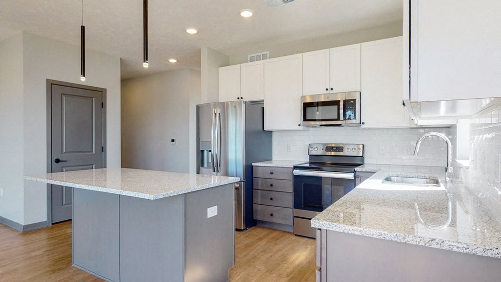 Two tone slate finishes in the Shine floor plan kitchen at Haven at Uptown in Lincoln, NE