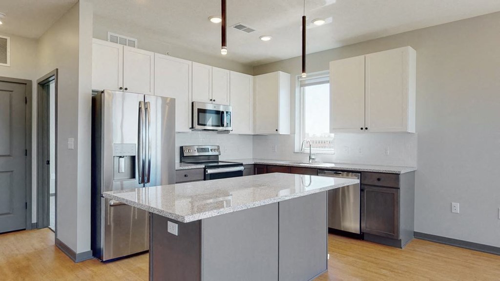 Kitchen and island seating with the slate finish style in the Shine floor plan at Haven at Uptown in Lincoln, NE