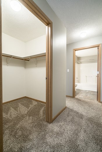 View into the doorways of a walk in closet and bathroom at Highland View - Photo Gallery 51