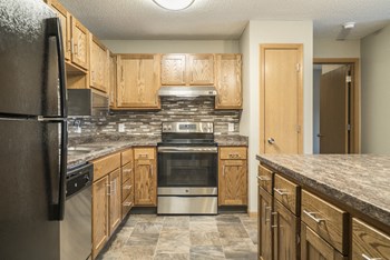 Interiors-Renovated kitchen with tile backsplash and new appliances at Highland View - Photo Gallery 40